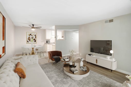 a living room with a white couch and a tv