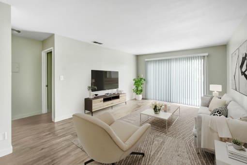 a living room with a couch and a chair and a television
