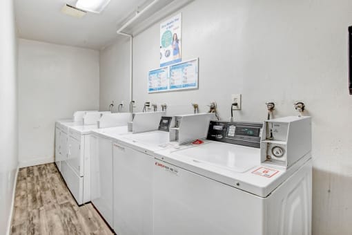 the laundry room is equipped with washes and dryers and has a counter top