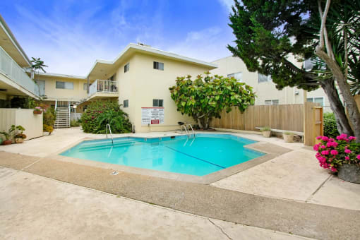a swimming pool in front of a house with a pool