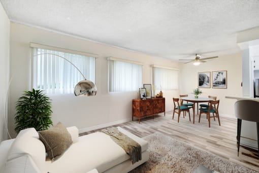 a living room and dining room with a couch and a table