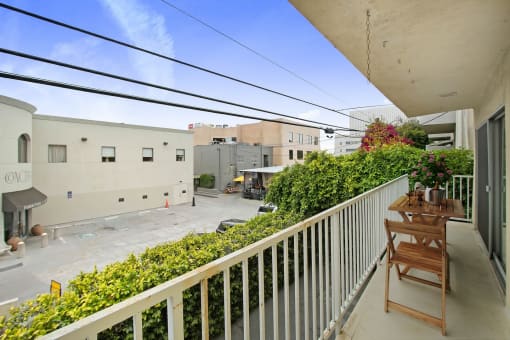 a balcony with a table and chairs and a patio