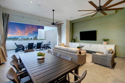 a large living room with a wooden table and chairs