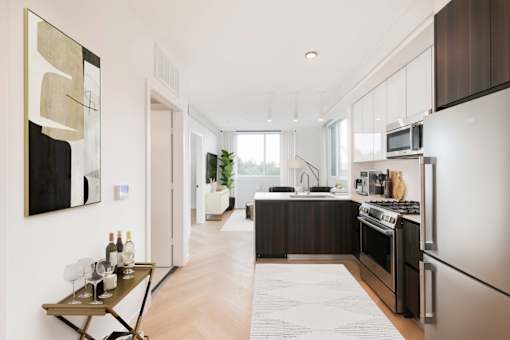 a kitchen with stainless steel appliances and a wood floor