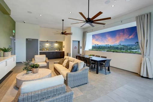 a living room with couches and a table and a large window