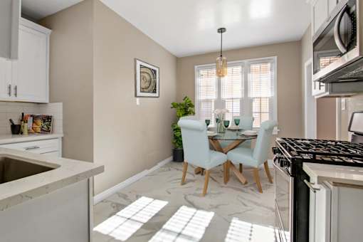 an open kitchen and dining room with a table and chairs