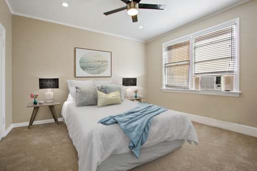 a bedroom with a bed and a ceiling fan