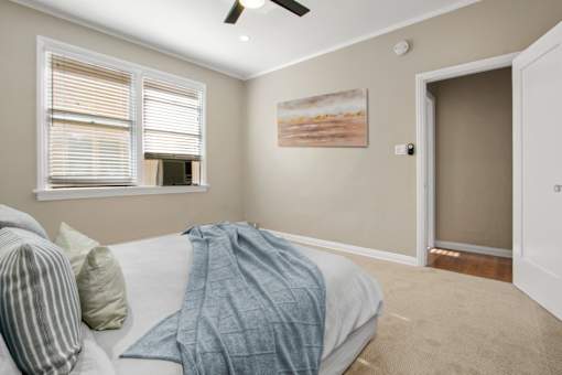 an empty bedroom with a bed and a window