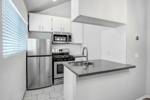 a kitchen with stainless steel appliances and a counter top