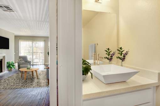 A bathroom with a white sink and a mirror.