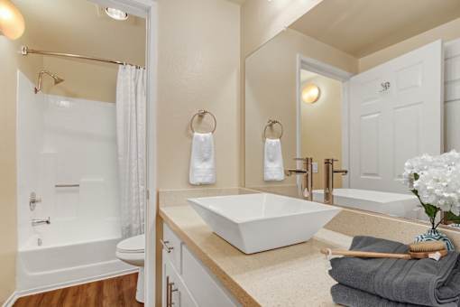 A white bathroom with a white tub and sink.