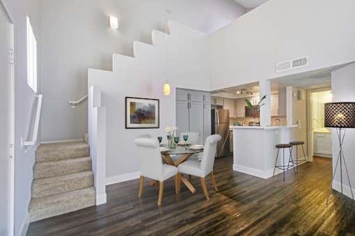 A dining room with a white table and chairs.
