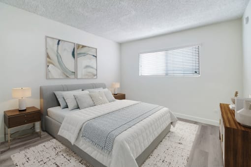 a bedroom with a large bed and a window