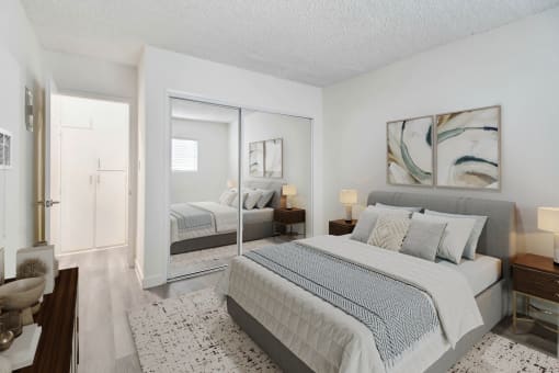a bedroom with a bed and a mirrored closet