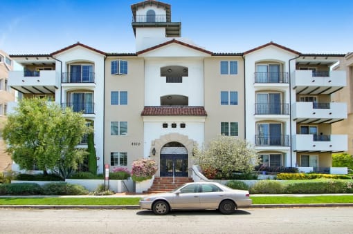 a car parked in front of an apartment building