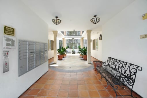 the lobby of a building with a bench and a door