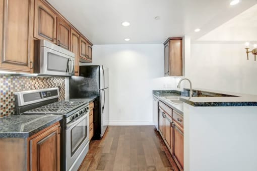 a kitchen with wooden cabinets and stainless steel appliances