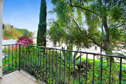 a balcony or terrace with a view of a garden