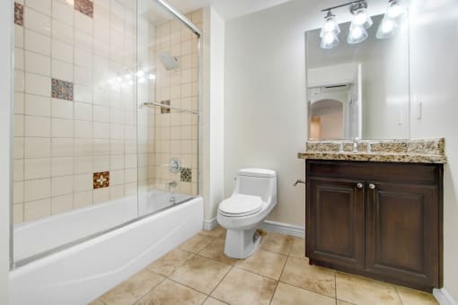 a bathroom with a toilet and a tub and a sink