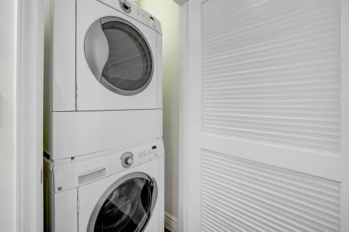 a white washer and dryer in a laundry room next to a white door