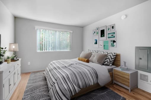 a bedroom with a bed and a rug