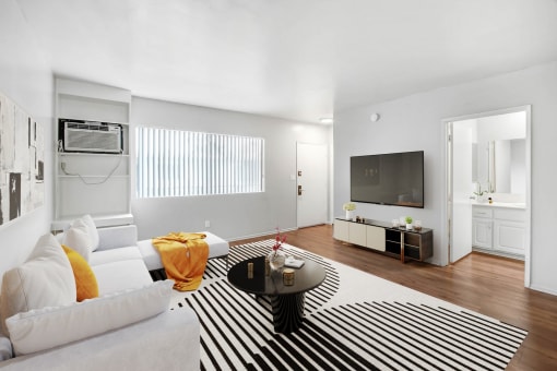 a living room with a white couch and a zebra rug