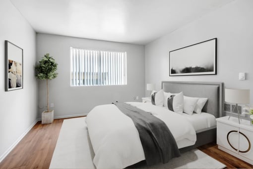 a bedroom with a large bed and a window