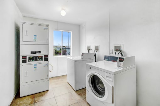laundry room with washer and dryer and a window
