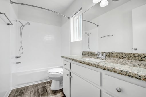a white bathroom with a sink and a toilet