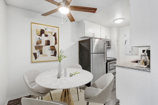 a kitchen and dining room with a white table and chairs