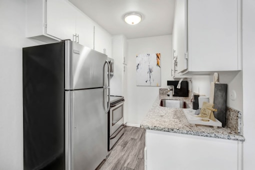 a kitchen with stainless steel appliances and granite counter tops