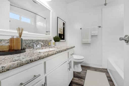 a white bathroom with a sink and a toilet
