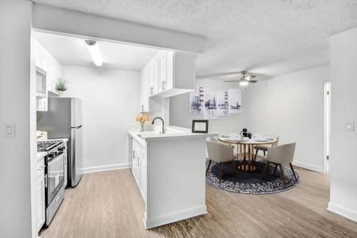 an open kitchen and dining room with a table and chairs