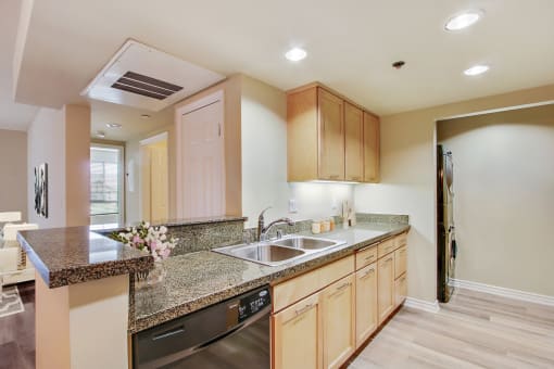 a kitchen with granite counter tops and a sink