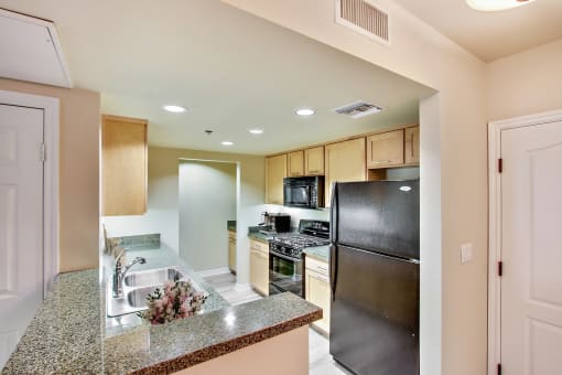 a kitchen with stainless steel appliances and granite counter tops
