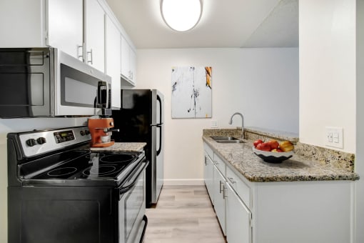 a kitchen with stainless steel appliances and granite counter tops