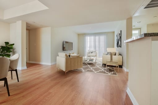 a living room and dining room with a hard wood floor
