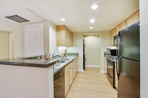 a kitchen with stainless steel appliances and granite counter tops