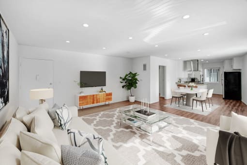 a living room with a white couch and a glass table