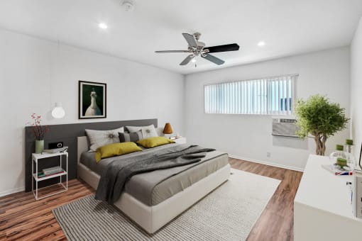 a bedroom with a bed and a ceiling fan
