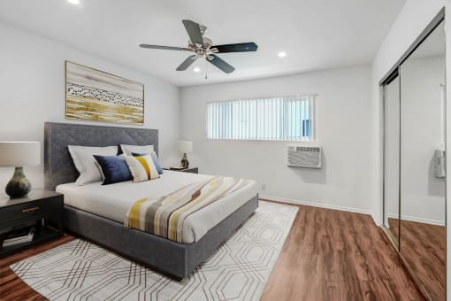 a bedroom with a bed and a ceiling fan