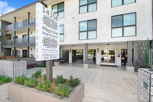 the front of a building with a sign in front of it