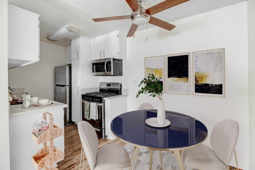an open kitchen and dining room with a blue table and chairs