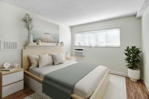a bedroom with a large bed and a plant