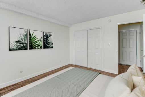 a bedroom with a bed and a door to a closet