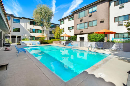 our apartments have a pool and lounge areas with umbrellas