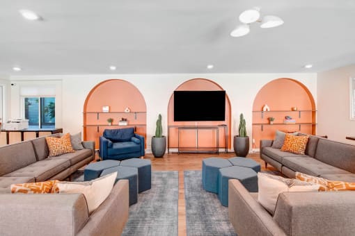 a living room with couches and chairs and a television