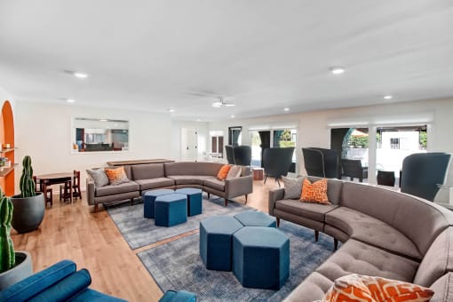 a living room with couches and chairs and a dining room with a table