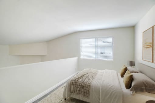a white bedroom with a bed and a window
