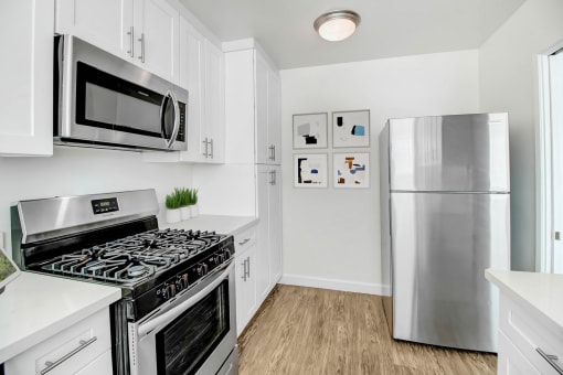 a kitchen with stainless steel appliances and a refrigerator